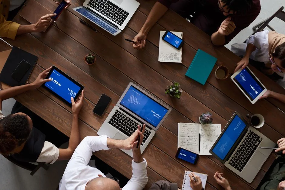 gallery-6 A person at a home office using a smartphone for stock market analysis.
